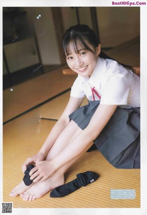 A woman in a school uniform is posing for a magazine.
