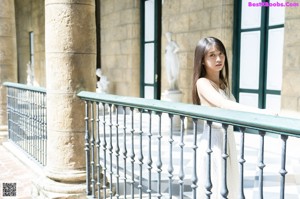 A woman in a black dress posing for a picture.