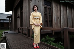 A woman in a white romper standing on a wooden floor.