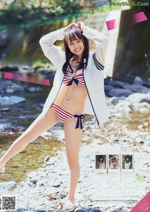 A woman in a red and white striped bikini holding a black jacket.