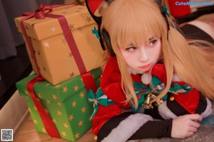 A woman dressed as a santa claus holding a present.