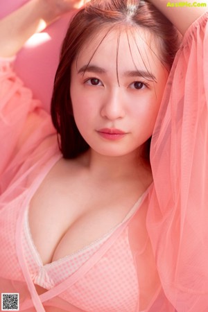 A woman in a pink lingerie posing for a picture.