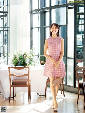 A woman in a white dress holding a glass of champagne.