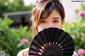 A woman in a colorful dress holding a fan.