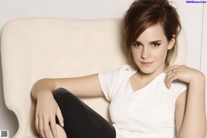 A woman in a black lingerie sitting on a blue couch.