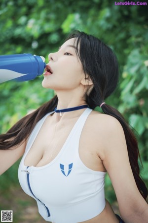 A woman in a blue and white outfit posing for a picture.