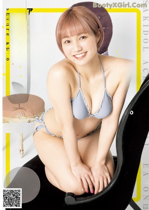 A woman in a purple bikini posing for a magazine cover.