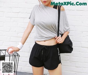 A woman in a black bra and black stockings posing for a picture.