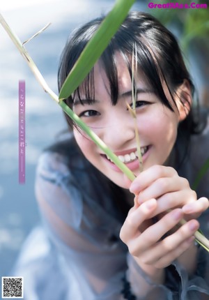 A woman with long black hair is posing for a magazine.