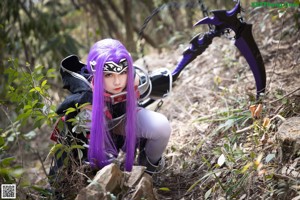 A woman with purple hair holding a sword in the woods.