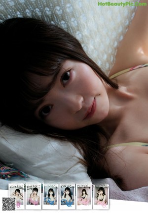 A woman in a bikini laying on a bed.