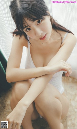 A woman in a purple bra and panties posing for a picture.