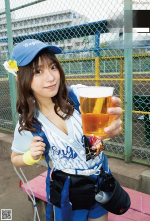 A woman in a white bra and blue panties is covered in foam.