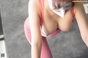 A woman in a pink bikini posing for the camera.