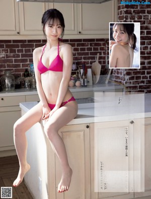 A woman in a white bra and panties posing for a picture.