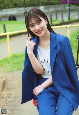 A woman in a white shirt and blue jeans posing for a picture.