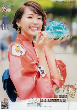 A woman in a kimono holding a bowl of ice cream.
